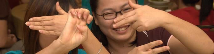 two asian women using sign language