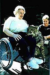 woman in wheelchair with cheetah cub